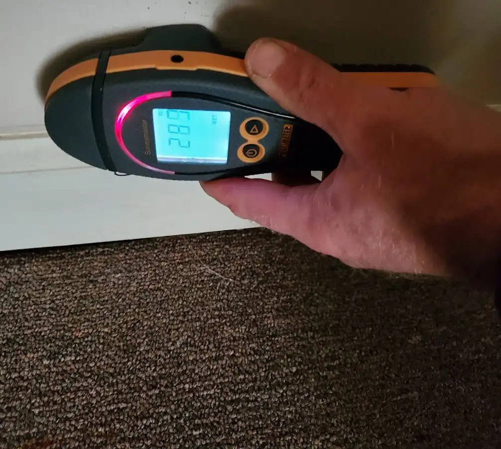 Moisture detection at baseboard during Storm Damage Restoration in South Boston